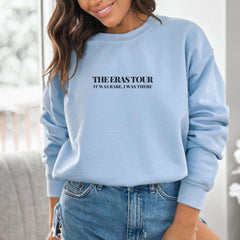 a woman wearing a blue sweatshirt that says, the erasour it's an