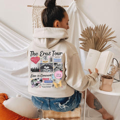 a woman sitting on a stool reading a book