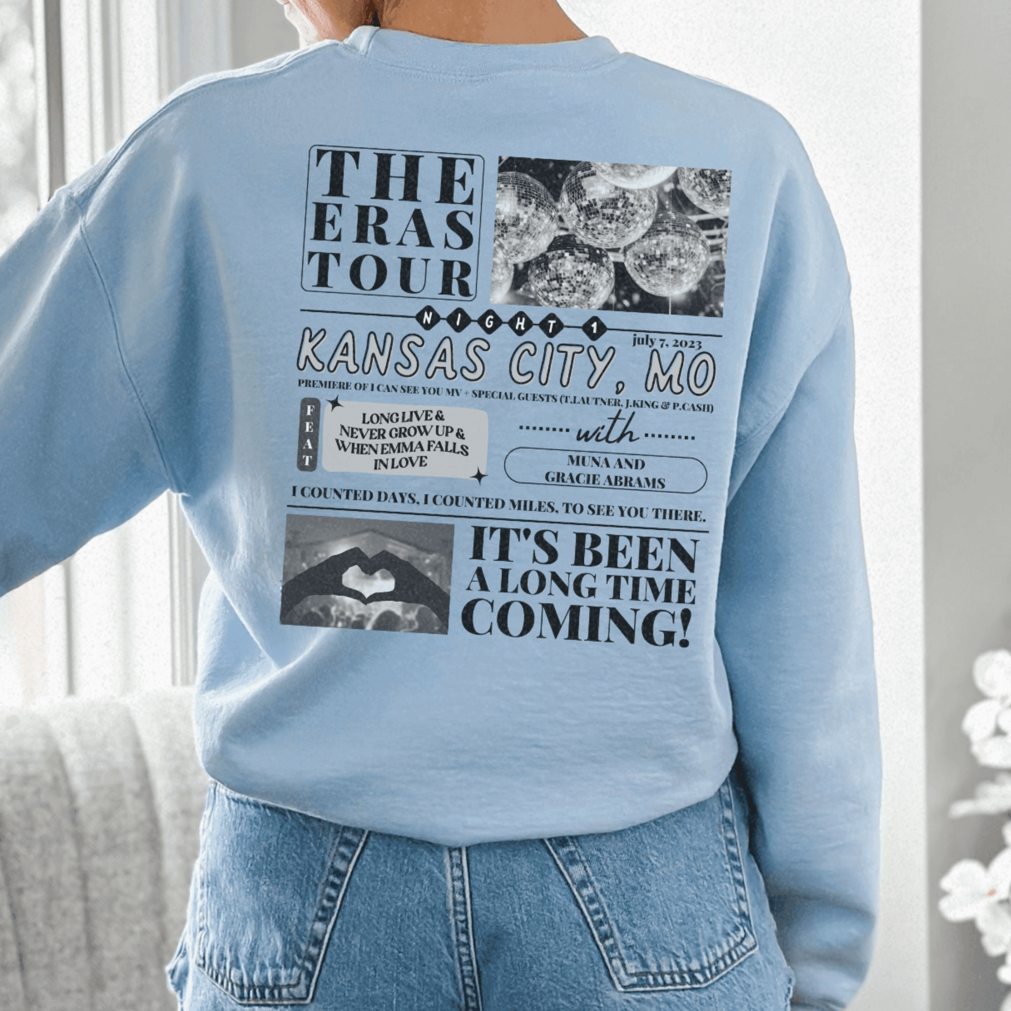 a woman wearing a blue sweatshirt with pictures on it
