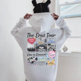 a person wearing a white hoodie with the words the grass tour printed on it
