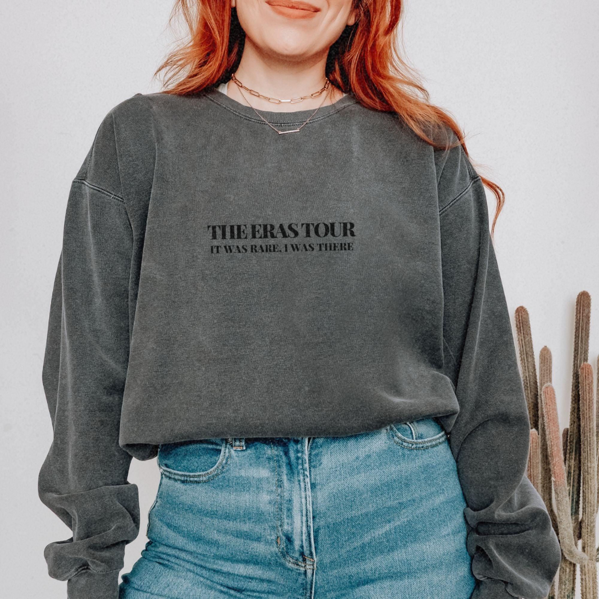 a woman with red hair wearing a black sweatshirt
