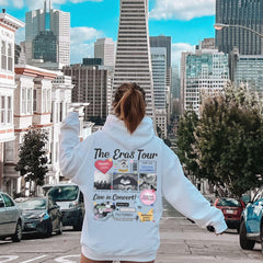 a woman riding a skateboard down a city street
