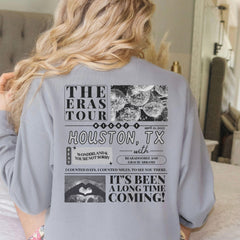 a woman in a gray shirt is standing on a bed