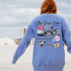 a woman in a blue sweatshirt is holding a skateboard