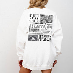 a woman wearing a white sweatshirt dress with the words atlanta on it