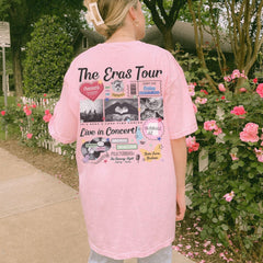 a woman in a pink shirt standing on a sidewalk