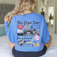 a woman sitting on a bed wearing a blue shirt