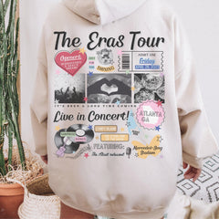 a person wearing a hoodie with the words the eras tour on it