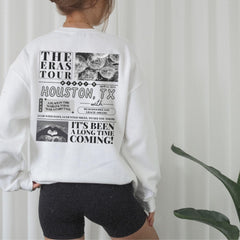 a woman wearing a white sweatshirt and black shorts