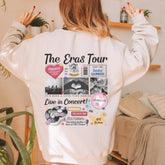 a woman wearing a white sweatshirt with the words the eras tour printed on it