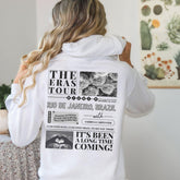 a woman wearing a white hoodie with the words the bras tour printed on