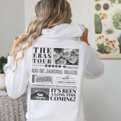 a woman wearing a white hoodie with the words the bras tour printed on