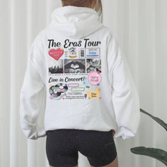 a woman wearing a white hoodie with the words the eras tour printed on it