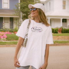 a woman wearing a white hat and a white shirt