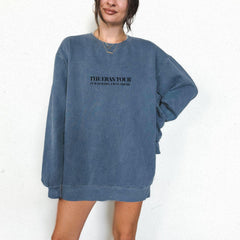 a woman wearing a blue sweatshirt dress with the words the eastside on it