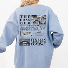 a woman wearing a blue sweatshirt with the words houston, tx on it