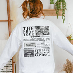 a woman wearing a white long sleeved shirt with pictures on it