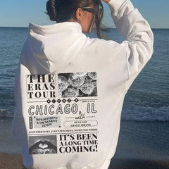 a woman standing on a beach with her back to the camera