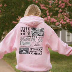 a girl in a pink hoodie is holding a frisbee