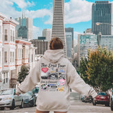 a woman in a hoodie walking down a street