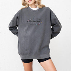 a woman wearing a grey sweatshirt with the words the great four printed on it