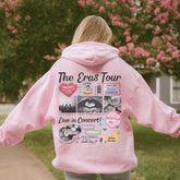 a woman in a pink hoodie is walking down a sidewalk