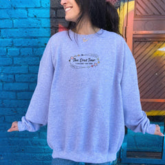 a woman standing in front of a blue brick wall