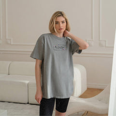 a woman standing in front of a white couch