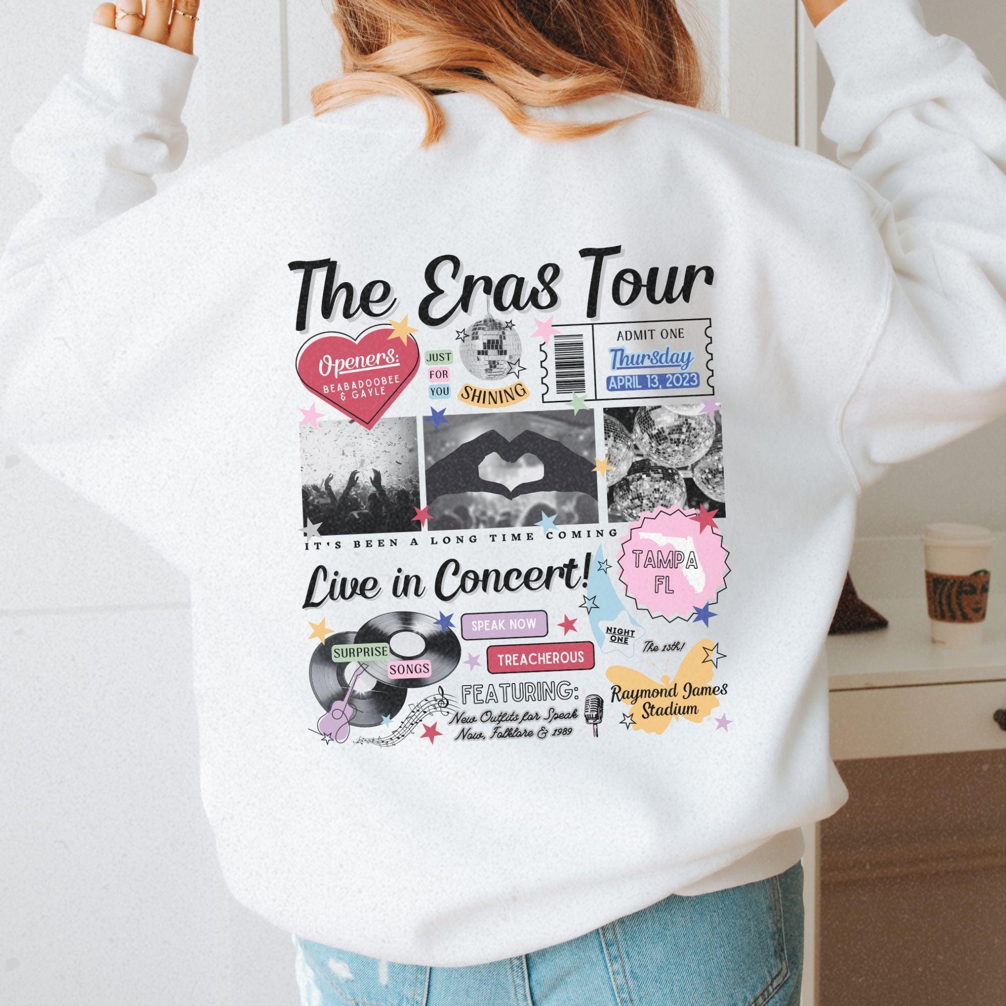 a woman wearing a white sweatshirt with the words the enas tour printed on it