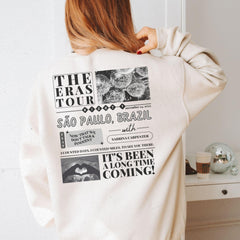 a woman wearing a white sweatshirt with black and white pictures on it