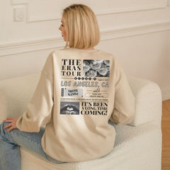 a woman sitting on a couch with her back to the camera