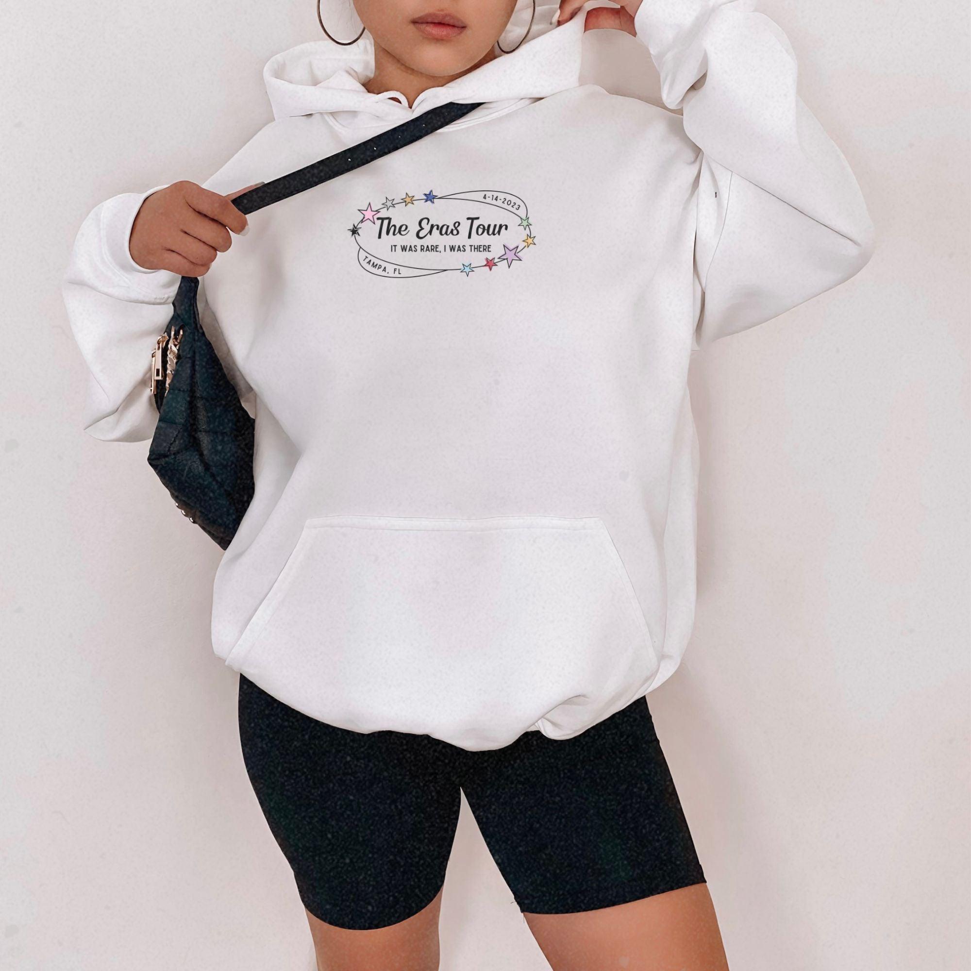 a woman in a white hoodie is posing for a picture