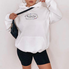 a woman in a white hoodie is posing for a picture