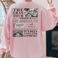 a pink sweatshirt with the words the eras tour on it