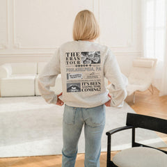 a woman standing in a living room with her back to the camera