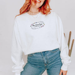a woman with red hair wearing a white sweatshirt