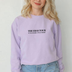 a blonde woman wearing a purple sweatshirt with the words the easy tour printed on it