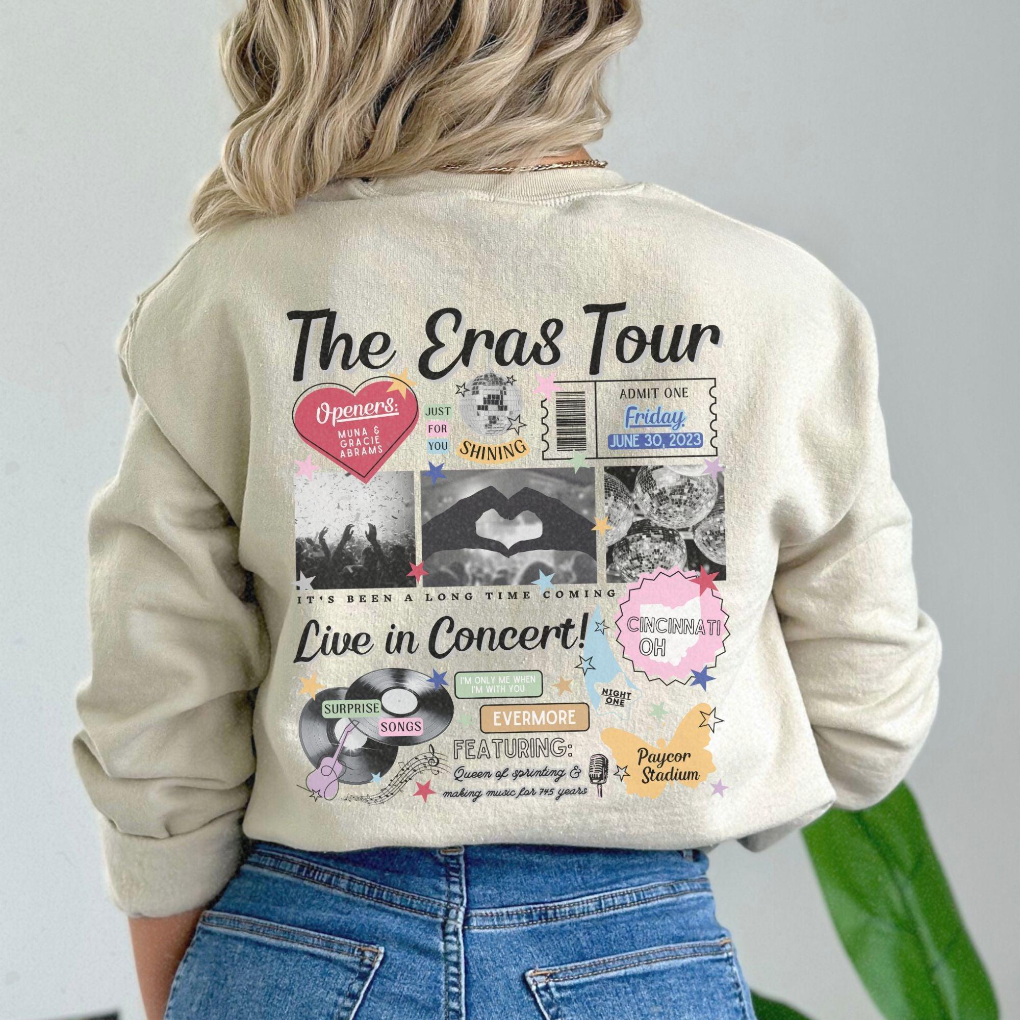 a woman wearing a sweatshirt with the words the eras tour on it