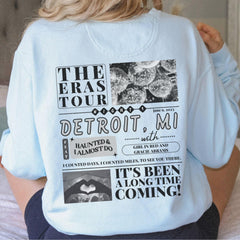 a woman sitting on a bed wearing a white shirt