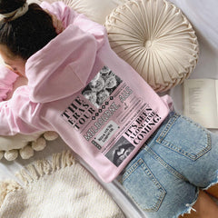 a woman laying on a bed with a pink shirt