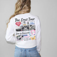 a woman wearing a white shirt with pictures on it