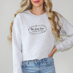 a woman wearing a grey sweatshirt with the words the end tour on it