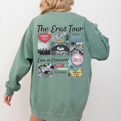 a woman wearing a green sweatshirt with the words the eras tour on it
