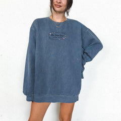 a woman standing in front of a white wall