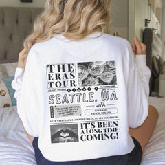 a woman sitting on a bed with her back to the camera