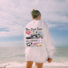 a woman standing on the beach looking at the ocean