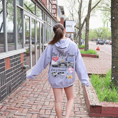 a woman walking down a sidewalk with a skateboard