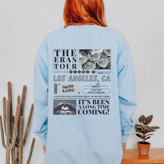 a woman with red hair wearing a blue sweatshirt