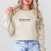 a woman with blonde hair wearing a sweatshirt and jeans