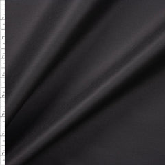 The image is a close-up view of a dark grey fabric, possibly a type of satin or velvet. The fabric appears to be smooth and shiny, with a slight sheen. The image does not contain any discernible objects or actions, and there are no texts or other objects present. The image focuses solely on the fabric, with no additional context or background information provided.